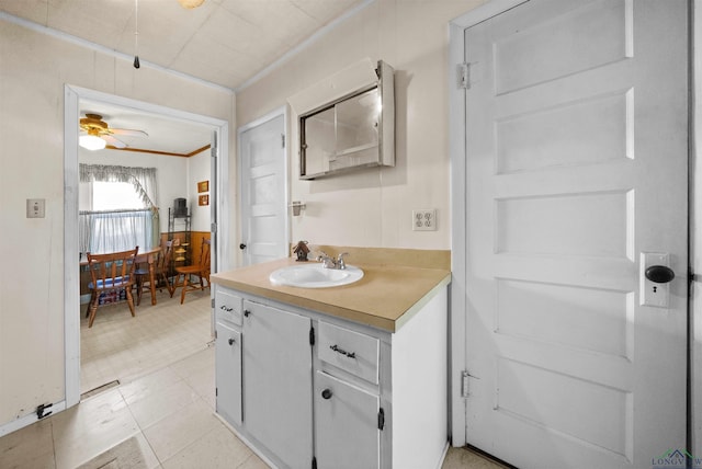 bathroom featuring vanity, crown molding, and ceiling fan