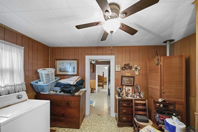 laundry area with washer / dryer, ceiling fan, and wood walls