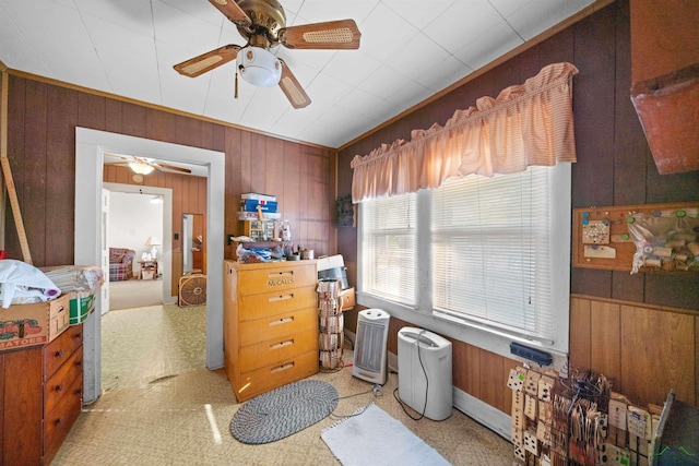 miscellaneous room with wooden walls and ceiling fan