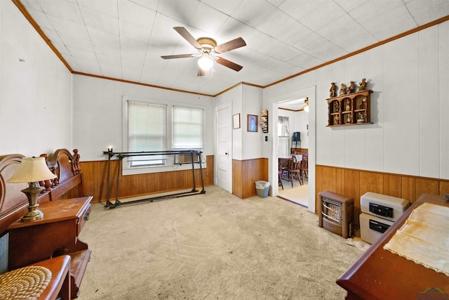 interior space featuring light carpet, wooden walls, ornamental molding, and ceiling fan