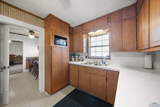 kitchen with sink, black microwave, and ceiling fan