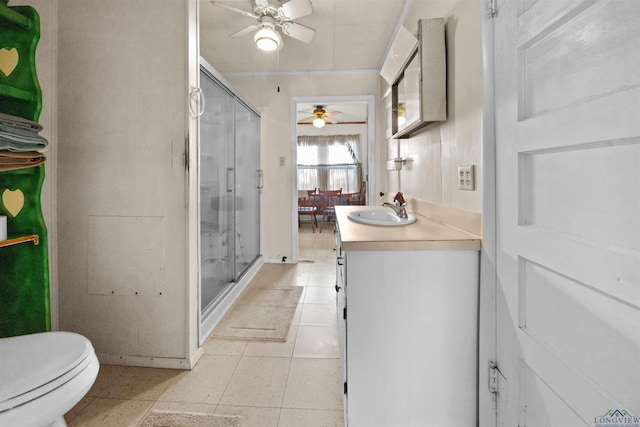 bathroom featuring tile patterned floors, toilet, an enclosed shower, vanity, and ceiling fan