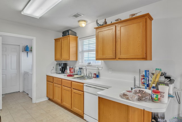 kitchen featuring white dishwasher, a sink, light tile patterned flooring, light countertops, and visible vents