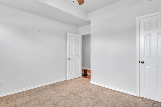 unfurnished bedroom featuring ceiling fan, baseboards, and carpet