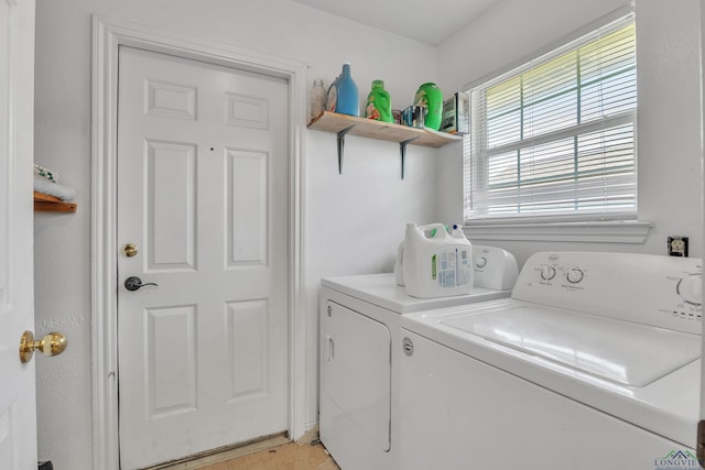 clothes washing area featuring washing machine and dryer and laundry area