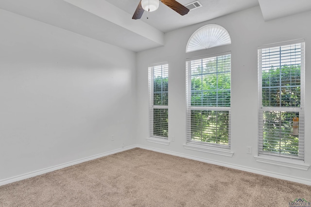 spare room with baseboards, a ceiling fan, carpet flooring, and visible vents