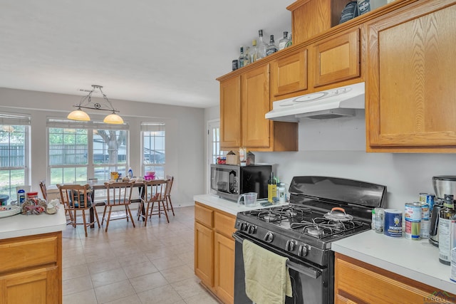 kitchen featuring light countertops, gas stove, and under cabinet range hood