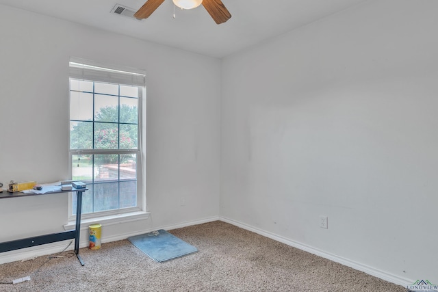 carpeted empty room featuring ceiling fan, baseboards, and visible vents