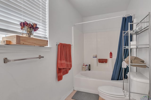 full bath with toilet, baseboards, and shower / bath combination with curtain