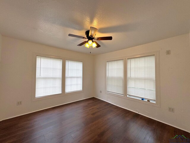 308 E 14th St, Mount Pleasant, TX 75455 - unfurnished room featuring a textured ceiling, dark wood-style floors, and a ceiling fan