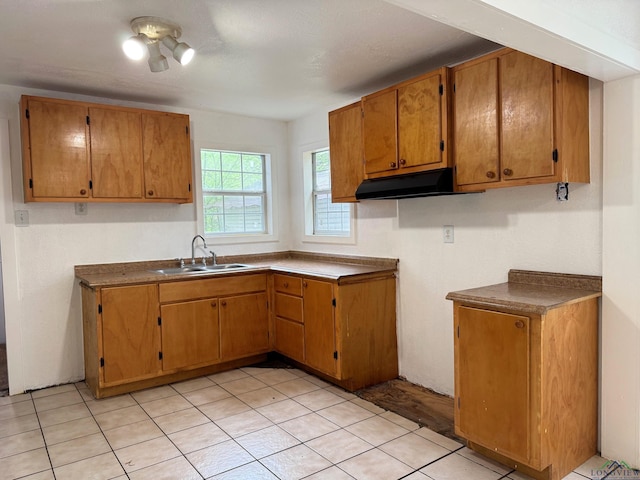 308 E 14th St, Mount Pleasant, TX 75455 - kitchen with brown cabinets, under cabinet range hood, and a sink