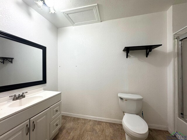 308 E 14th St, Mount Pleasant, TX 75455 - full bath featuring baseboards, wood finished floors, toilet, and vanity