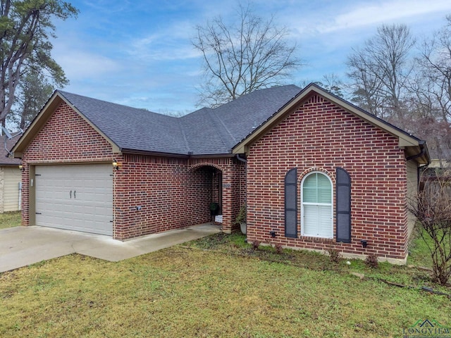 ranch-style home with brick siding, a shingled roof, concrete driveway, a front yard, and a garage