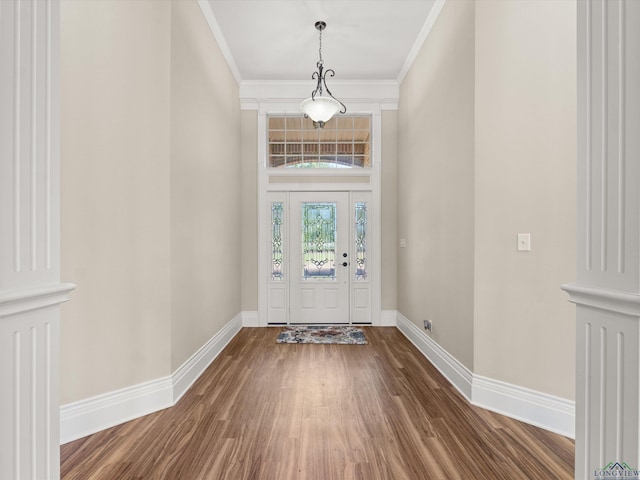 entrance foyer featuring crown molding and wood-type flooring