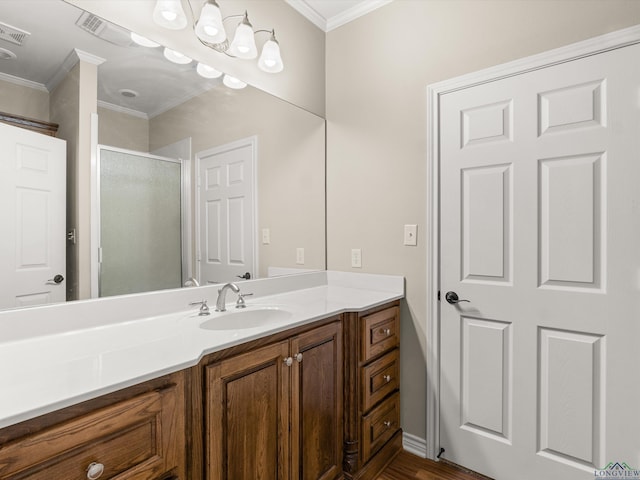 bathroom with crown molding, vanity, and walk in shower