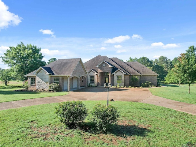 view of front of property with a front yard and a garage