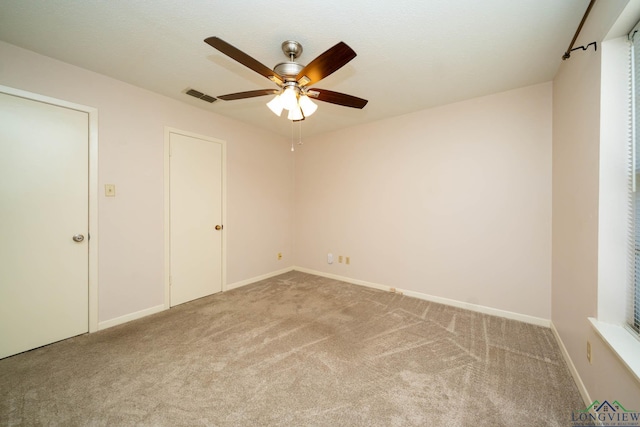 unfurnished bedroom featuring ceiling fan and carpet