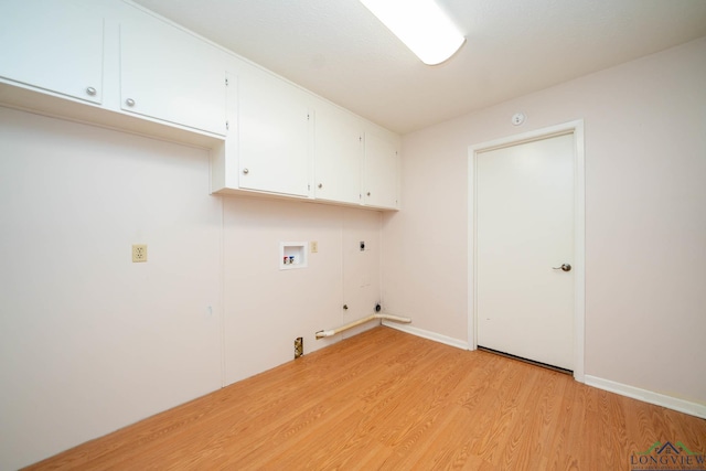 washroom featuring cabinets, hookup for an electric dryer, hookup for a gas dryer, light hardwood / wood-style flooring, and hookup for a washing machine