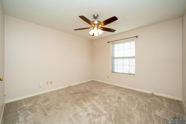 empty room featuring ceiling fan and light colored carpet