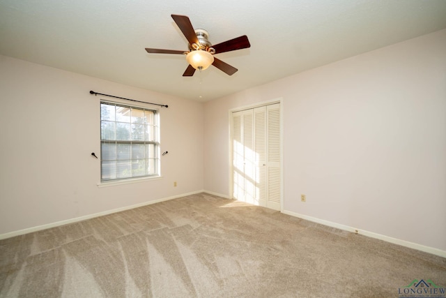 carpeted empty room with ceiling fan