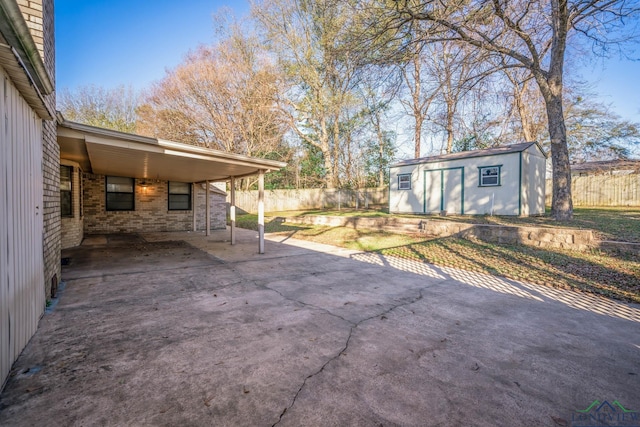 view of patio with a carport and a storage shed