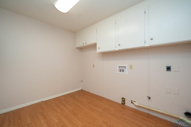 clothes washing area featuring cabinets, washer hookup, hookup for an electric dryer, light hardwood / wood-style flooring, and gas dryer hookup