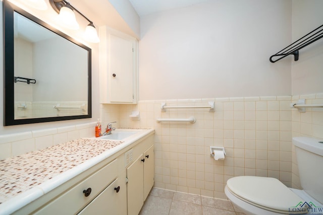 bathroom with tile patterned flooring, vanity, toilet, and tile walls