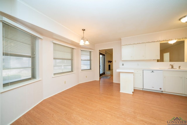 kitchen featuring white dishwasher, light hardwood / wood-style floors, white cabinets, and hanging light fixtures