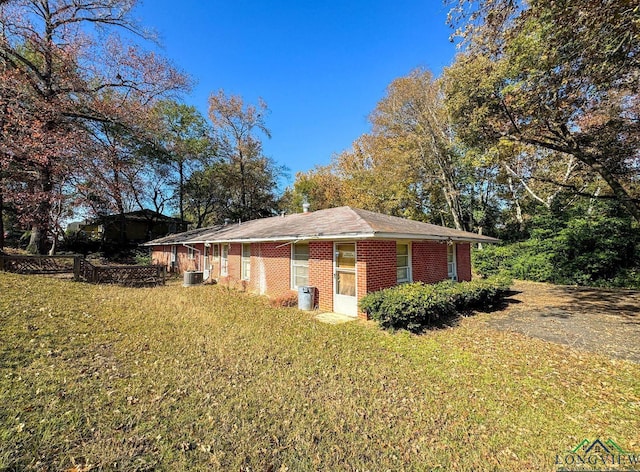 view of home's exterior with a lawn and central air condition unit