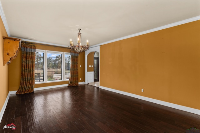 empty room featuring crown molding, a chandelier, and wood-type flooring