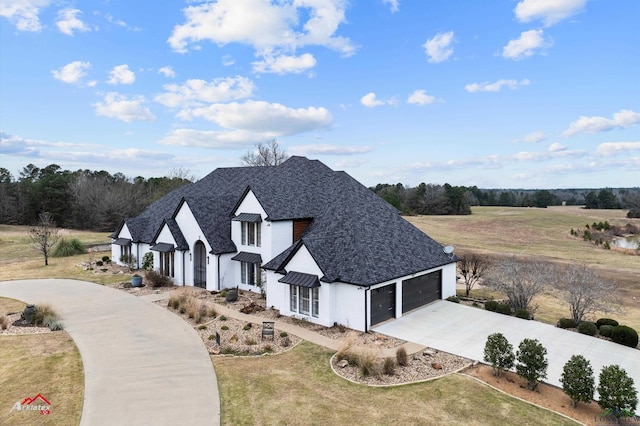 view of front of house with a garage and a front lawn