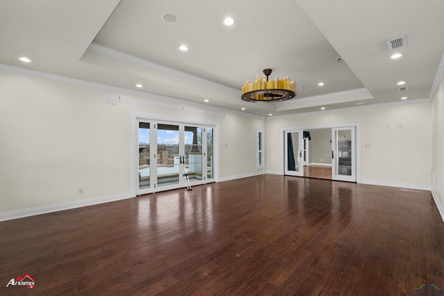 unfurnished living room featuring french doors, dark hardwood / wood-style flooring, a raised ceiling, and crown molding