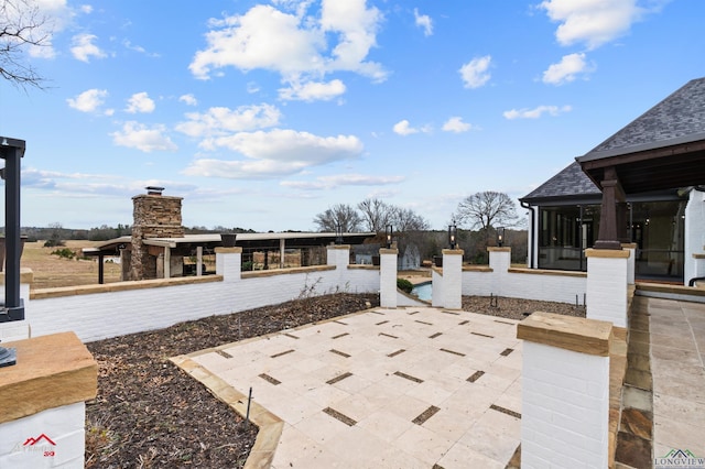 view of patio featuring a sunroom and a pool