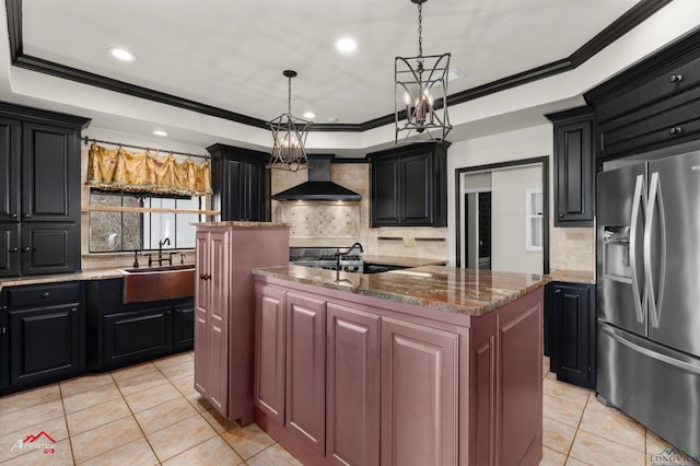 kitchen featuring sink, a center island, tasteful backsplash, stainless steel refrigerator with ice dispenser, and custom range hood