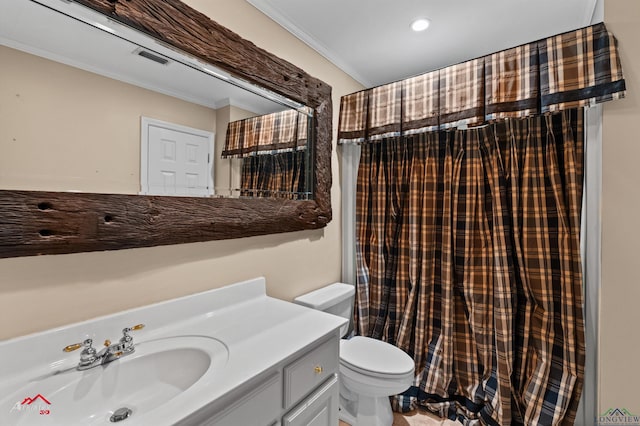 bathroom with vanity, toilet, and crown molding