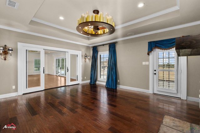 unfurnished room featuring french doors, a raised ceiling, plenty of natural light, and crown molding