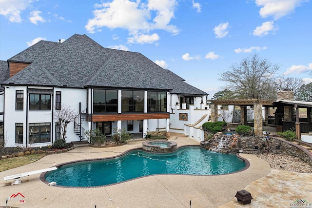 view of pool featuring a patio area and an in ground hot tub