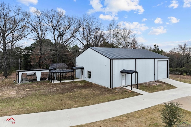 view of outbuilding with a lawn and a garage