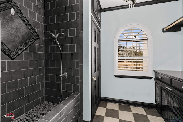 bathroom featuring tiled shower and vanity