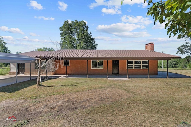 single story home with a front yard and a carport