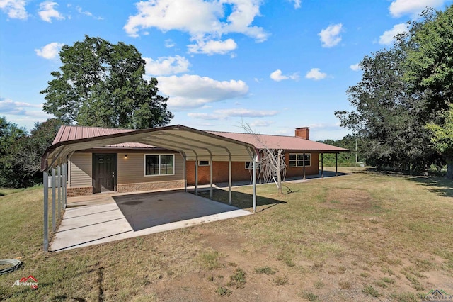 exterior space with a lawn and a carport