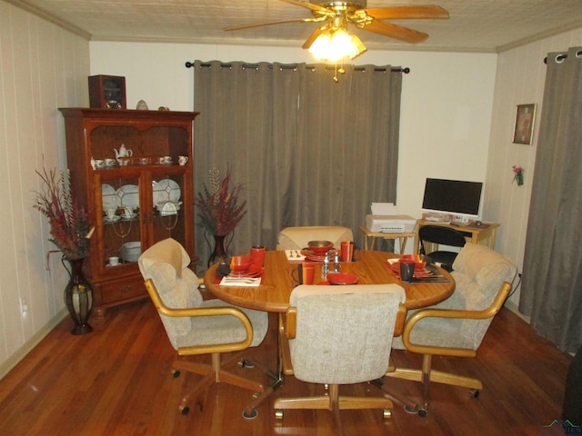 dining space featuring crown molding, ceiling fan, and wood finished floors