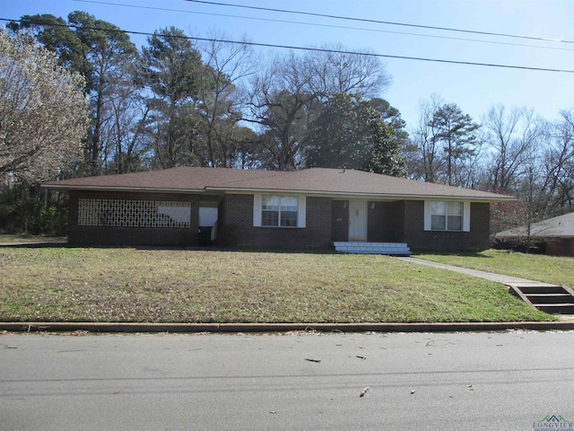 view of front of home with a front yard and brick siding