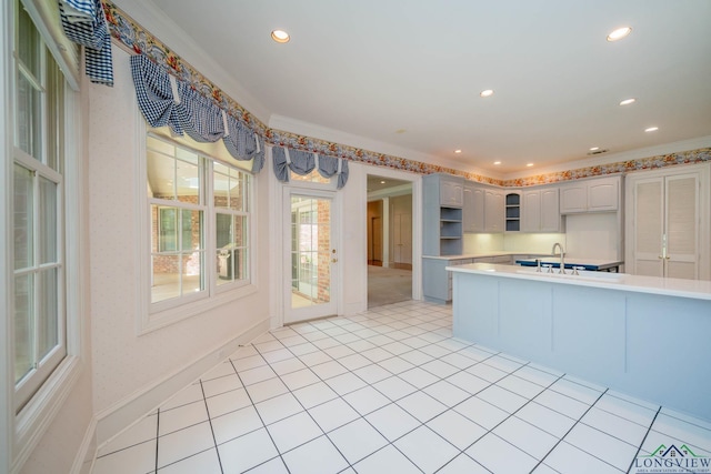 7 Summer Creek Way, Longview, TX 75604 - kitchen with light countertops, recessed lighting, glass insert cabinets, ornamental molding, and light tile patterned floors