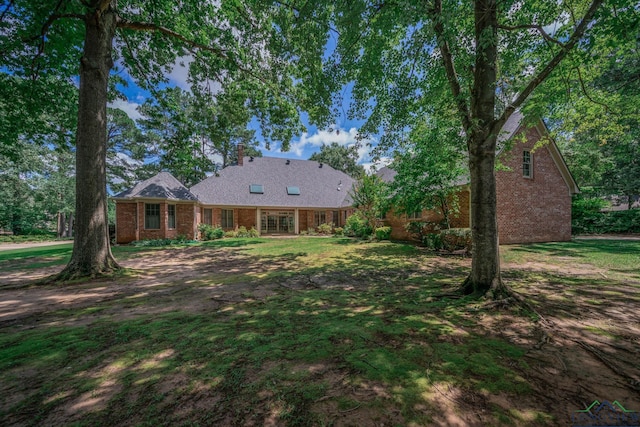 7 Summer Creek Way, Longview, TX 75604 - view of front facade with brick siding, a chimney, and a front yard