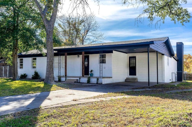 ranch-style house with covered porch and a front lawn