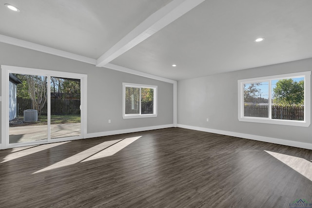 spare room with vaulted ceiling with beams, dark hardwood / wood-style floors, and plenty of natural light