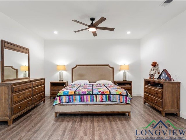 bedroom with hardwood / wood-style floors and ceiling fan