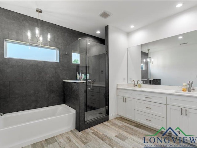 bathroom featuring hardwood / wood-style floors, vanity, independent shower and bath, and a wealth of natural light