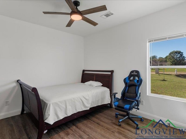 bedroom with dark hardwood / wood-style flooring and ceiling fan